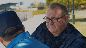 RSL Education veteran sitting on bench talking to another veteran